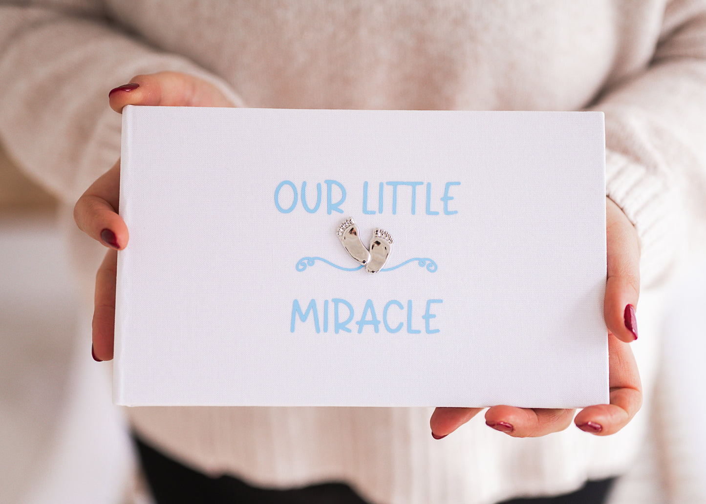 Our little miracle ~ Gorgeous shiny footprint design on a smart white linen album with soft blue/pink printed design